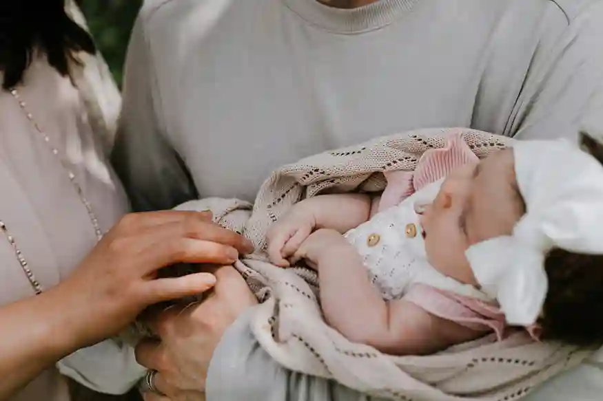 Parents Holding Baby Together