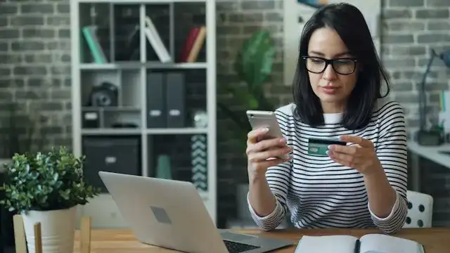 Single mom reviewing her checking account and monthly budget